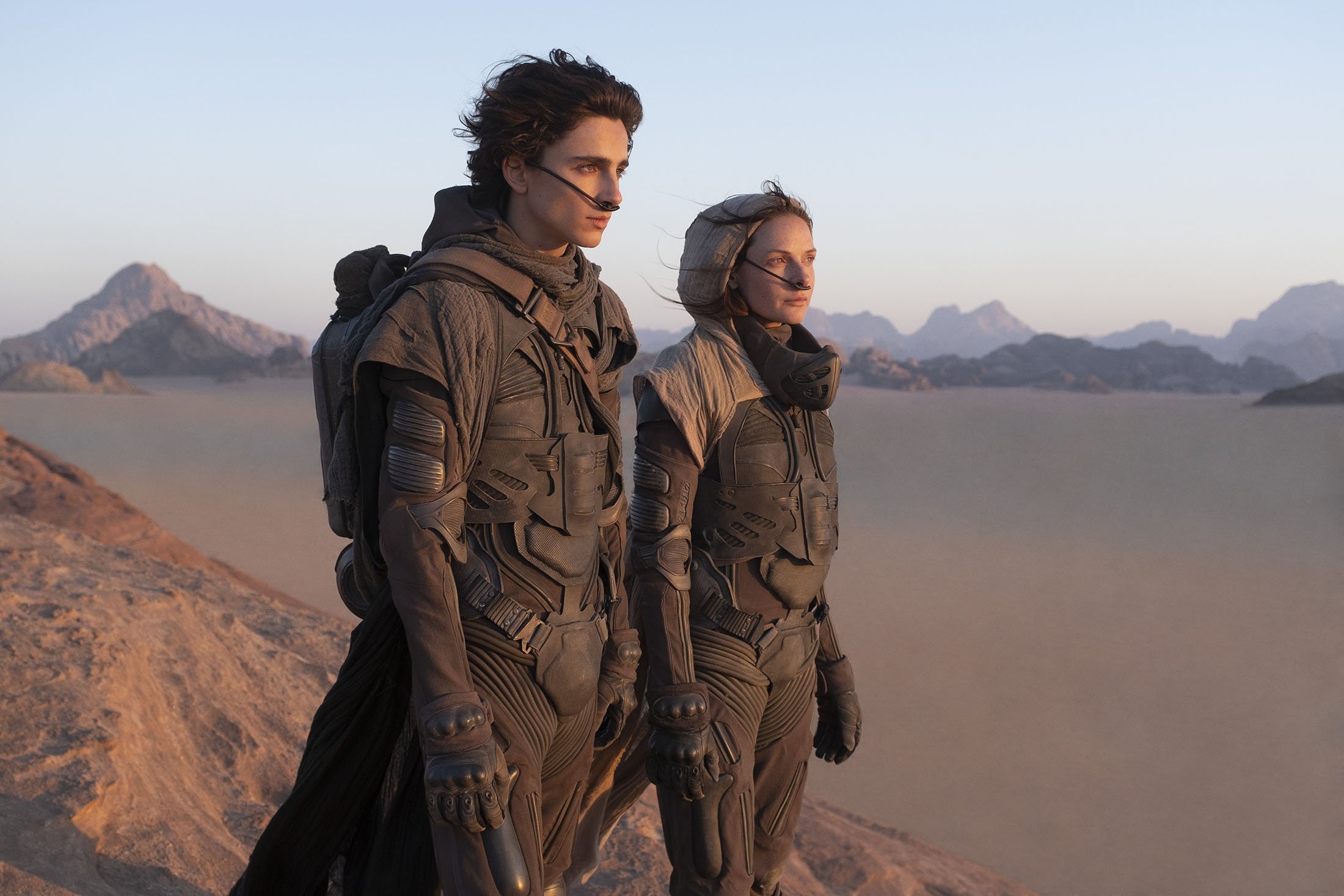 Timothee Chalamet (L), and Rebecca Ferguson, in a scene from the upcoming 2021 film "Dune." (Warner Bros. via AP)