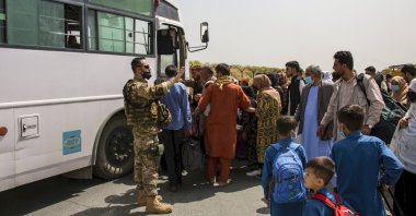 In this image provided by the U.S. Marine Corps, German military members process evacuees at Hamid Karzai International Airport in Kabul, Afghanistan, Aug. 28, 2021. (AP Photo)