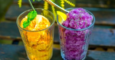 Glasses of fresh orange sorbet (L) and fresh grape sorbet (R). (Shutterstock Photo)