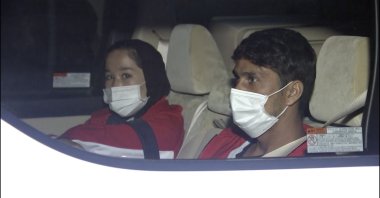 In this image made from a video, Afghan athletes Zakia Khudadadi (L) and Hossain Rasouli arrive at Haneda airport, Tokyo, Japan, Saturday, Aug. 28, 2021. (AP Photo)