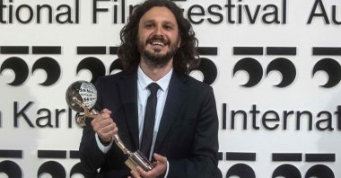 Serbian director Stefan Arsenijevic poses with the Crystal Globe for Best Film for his film "As Far As I Can Walk" at the 55th Karlovy Vary International Film Festival (KVIFF) in Karlovy Vary, Czech Republic, Aug. 28, 2021. (AFP Photo)