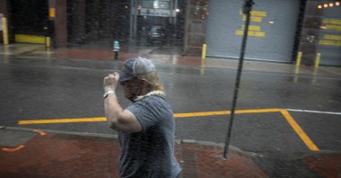 A woman walks in the rain as Hurricane Ida makes landfall in Louisiana, in New Orleans, Louisiana, U.S. Aug. 29, 2021. (REUTERS)