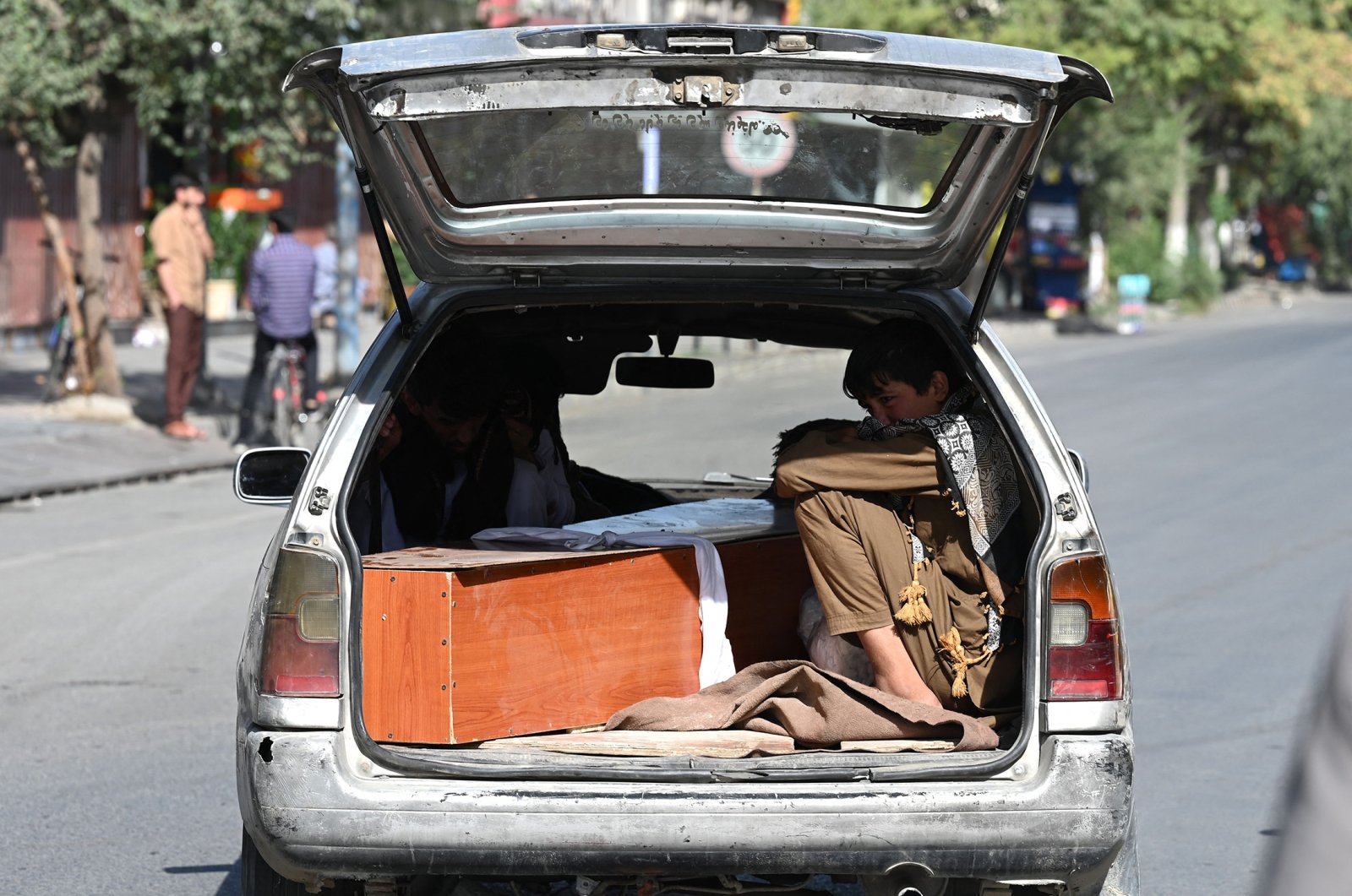 Relatives transport a coffin of a victim of the Aug. 26 twin suicide bombings outside Kabul Hamid Karzai International Airport, Kabul, Afghanistan, Aug. 27, 2021. (AFP Photo)