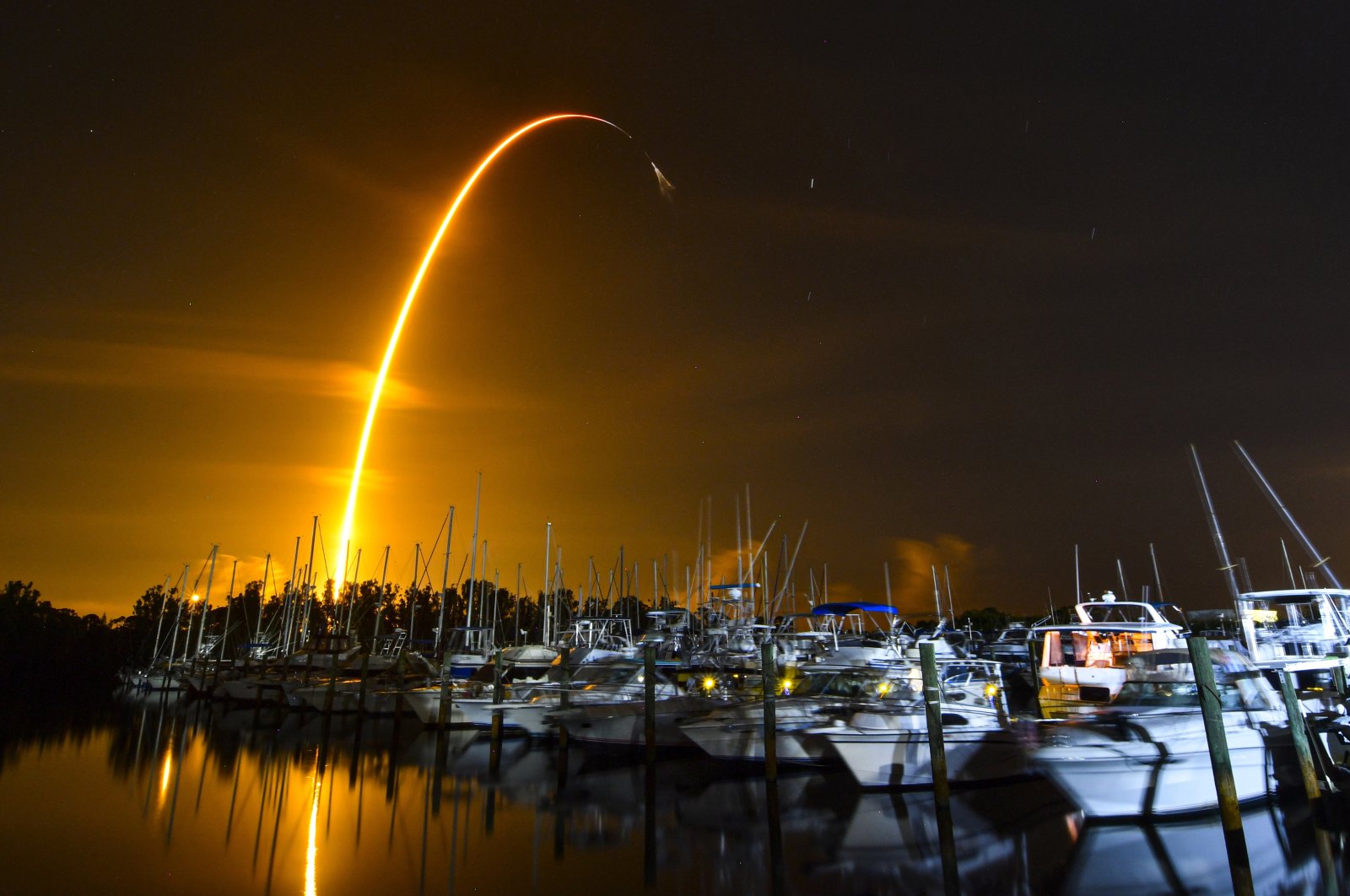This long exposure photo shows the launch of a SpaceX Falcon 9 rocket on a resupply mission for NASA to the International Space Station from Pad 39A at Kennedy Space Center, seen from Merritt Island, Fla., U.S., Aug. 29, 2021. (AP Photo)