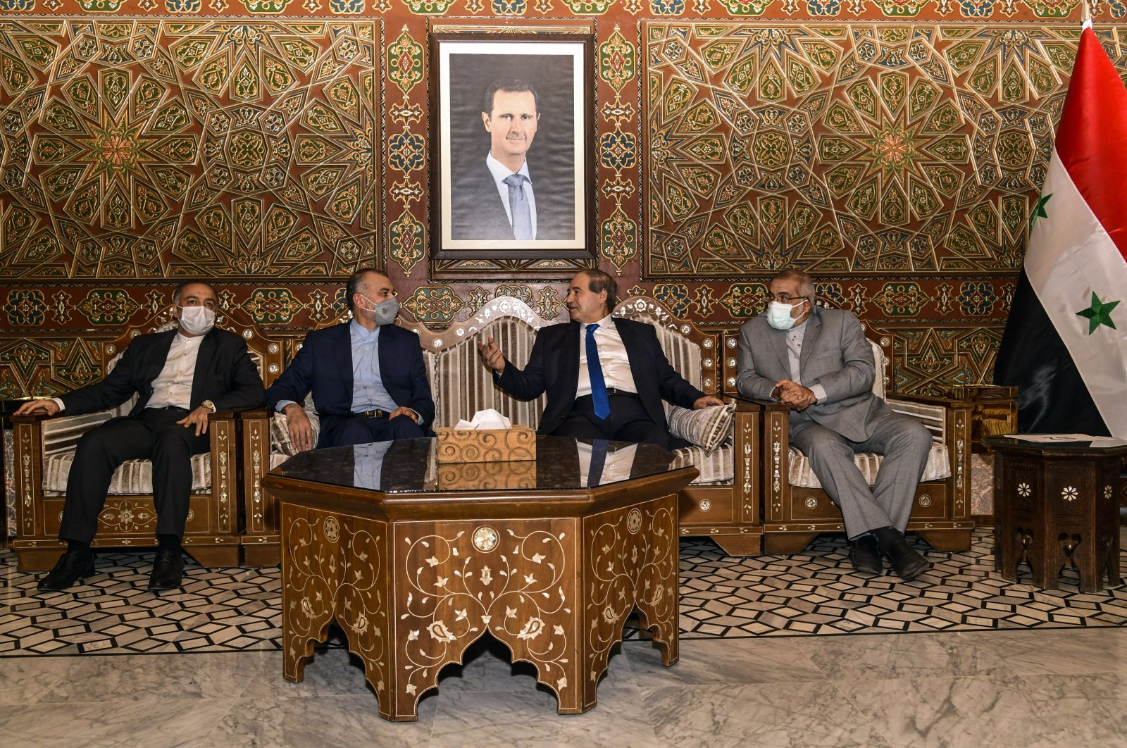 Syria's Foreign Minister Faisal Mekdad, (2-R), receives Iran's new Foreign Minister Hossein Amir-Abdollahian, (2-L), in Damascus, Syria, Sunday, Aug. 29, 2021. (SANA via AP)