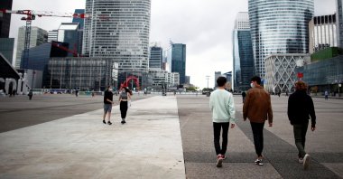 People walk through the financial and business district of La Defense in Puteaux near Paris, France, Aug. 23, 2021. (Reuters Photo)