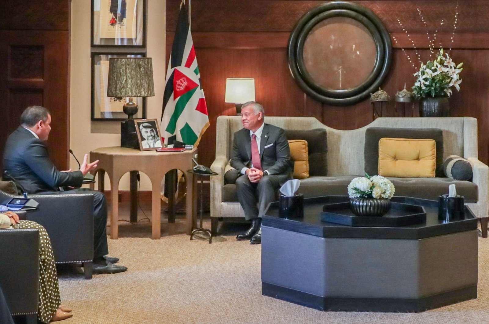 A handout picture released by the Jordanian Royal Palace shows Jordanian King Abdullah II (C) receiving Libyan Prime Minister Abdul Hamid Dbeibah (L) in the capital Amman, Aug. 29, 2021. (Photo by Yousef Allan / Jordanian Royal Palace / AFP) 