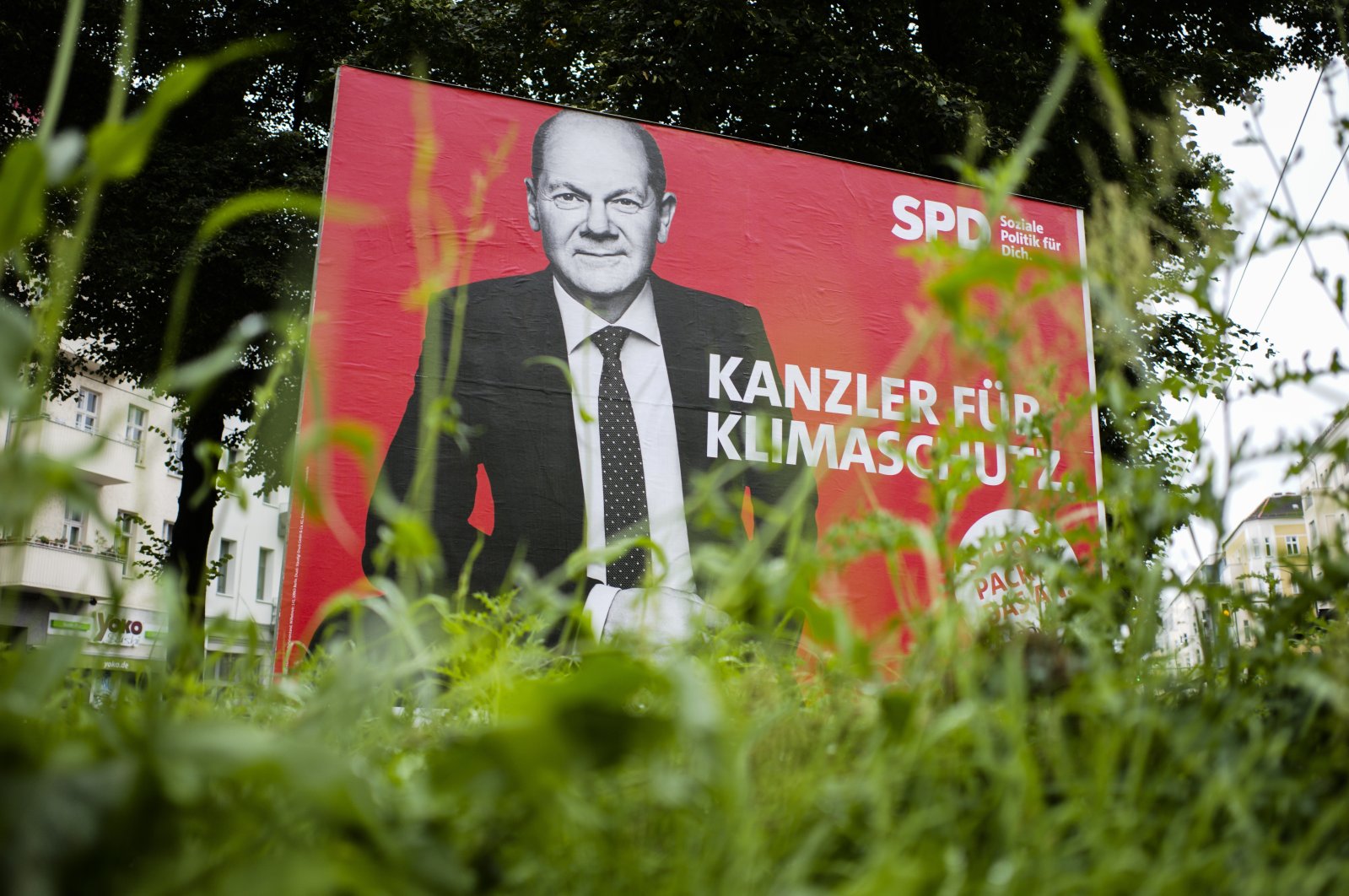 The SPD candidate for chancellor Olaf Scholz is displayed on an election campaign poster reading: “Chancellor for climate protection”, near a street in Berlin, Germany, Aug. 30, 2021. (AP Photo)