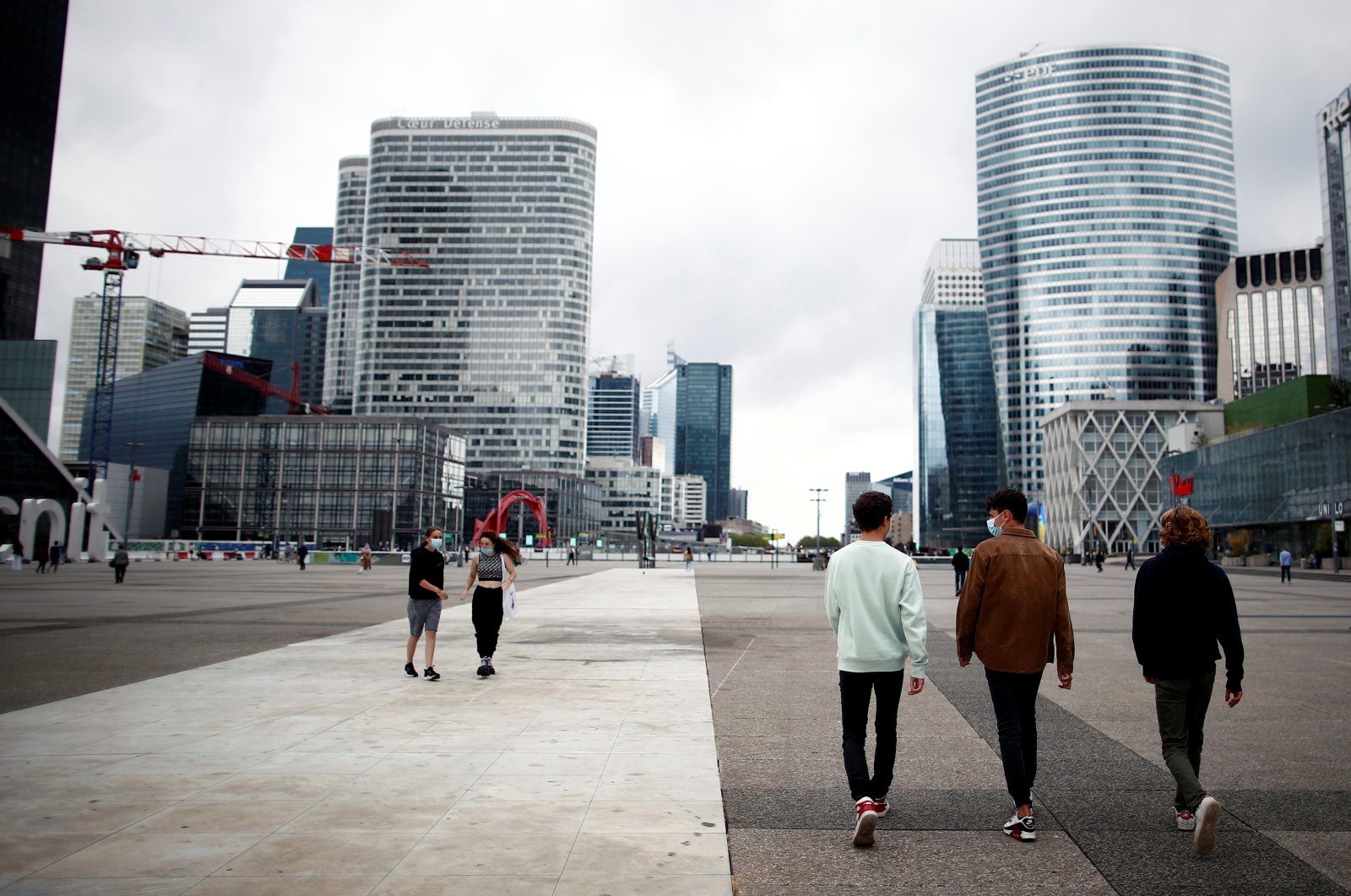 People walk through the financial and business district of La Defense in Puteaux near Paris, France, Aug. 23, 2021. (Reuters Photo)