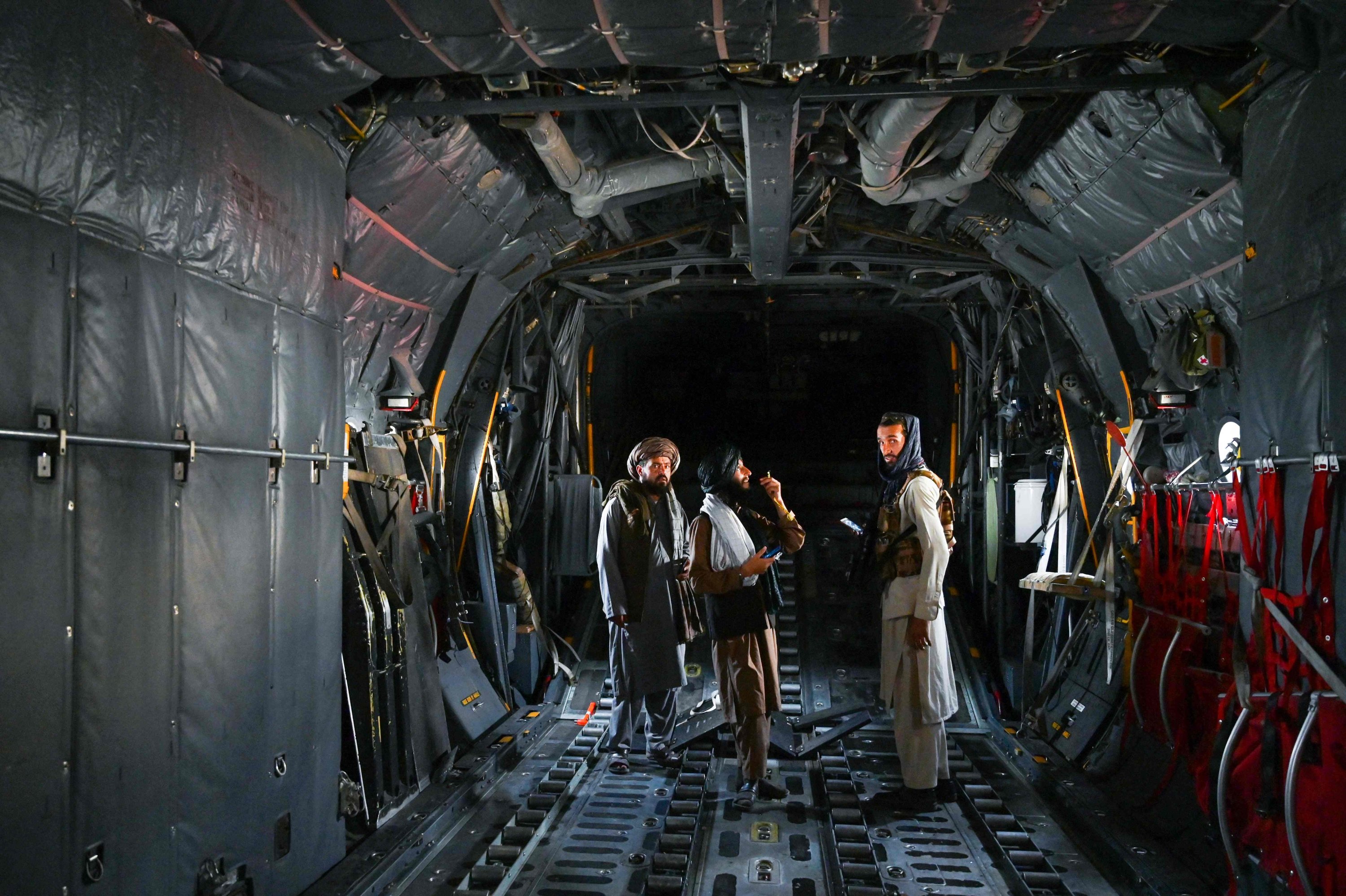 Taliban fighters stand inside an Afghan Air Force aircraft at the airport in Kabul on August 31, 2021, after the U.S. pulled all its troops out of the country to end a brutal 20-year war. (AFP Photo)