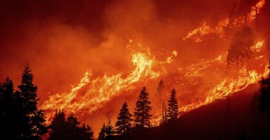 Flames from the Caldor Fire leap along a hillside above Christmas Valley, South Lake Tahoe, California, U.S., Aug. 30, 2021. (AP Photo)