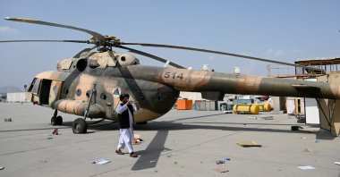 A Taliban member takes photos with a mobile phone at the airport in Kabul, Afghanistan, Aug. 31, 2021. (AFP Photo)