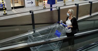 A woman pushes a shopping trolley past a sign for a COVID-19 vaccination center installed inside a supermarket in Brussels, Belgium, Aug. 30, 2021. (Reuters Photo)