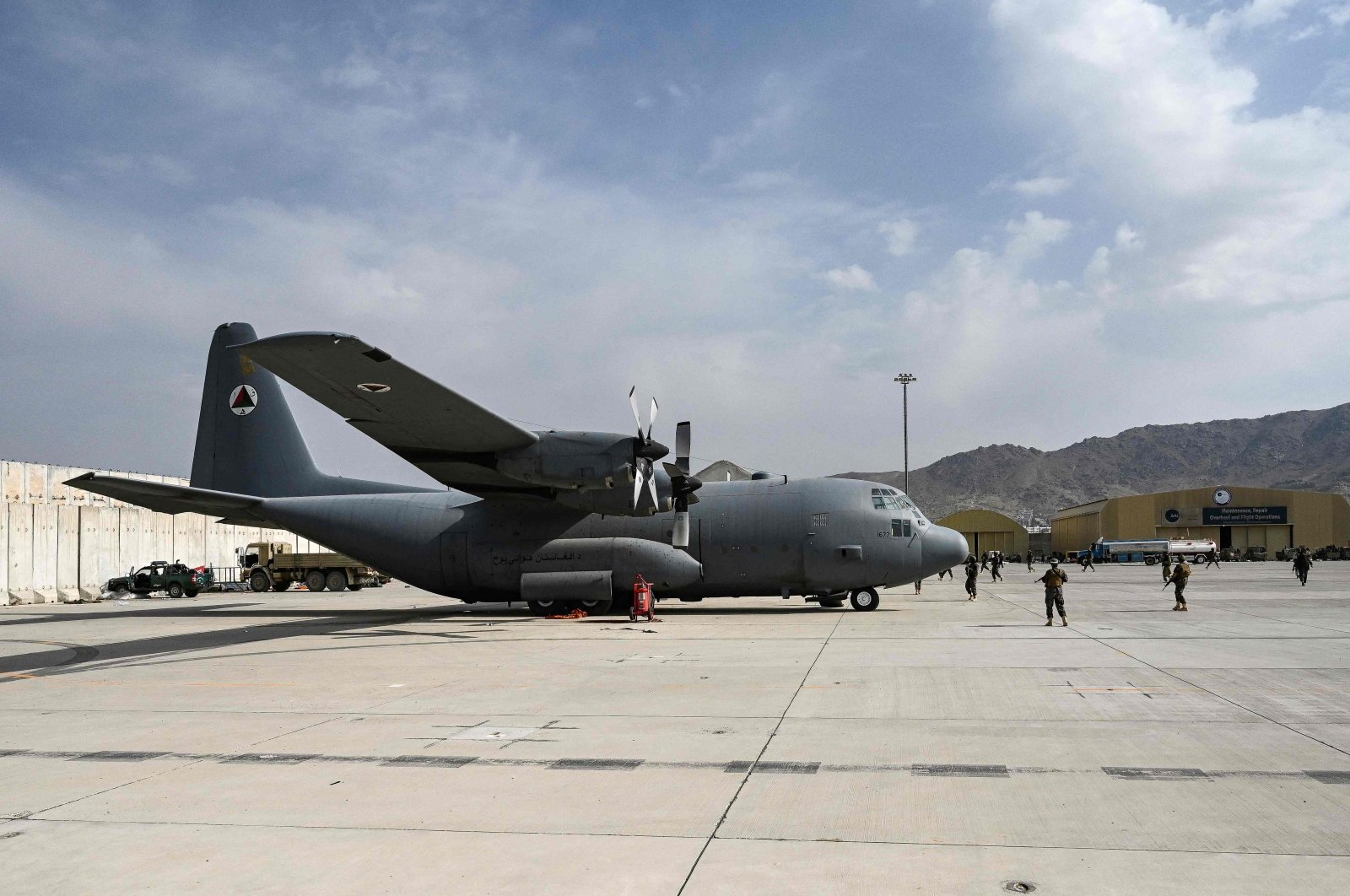 Taliban Badri special force fighters stand guard next to an Afghan Air Force aircraft at the airport in Kabul, Afghanistan, Aug. 31, 2021, after the U.S. pulled all its troops out of the country to end a brutal 20-year war. (AFP Photo)