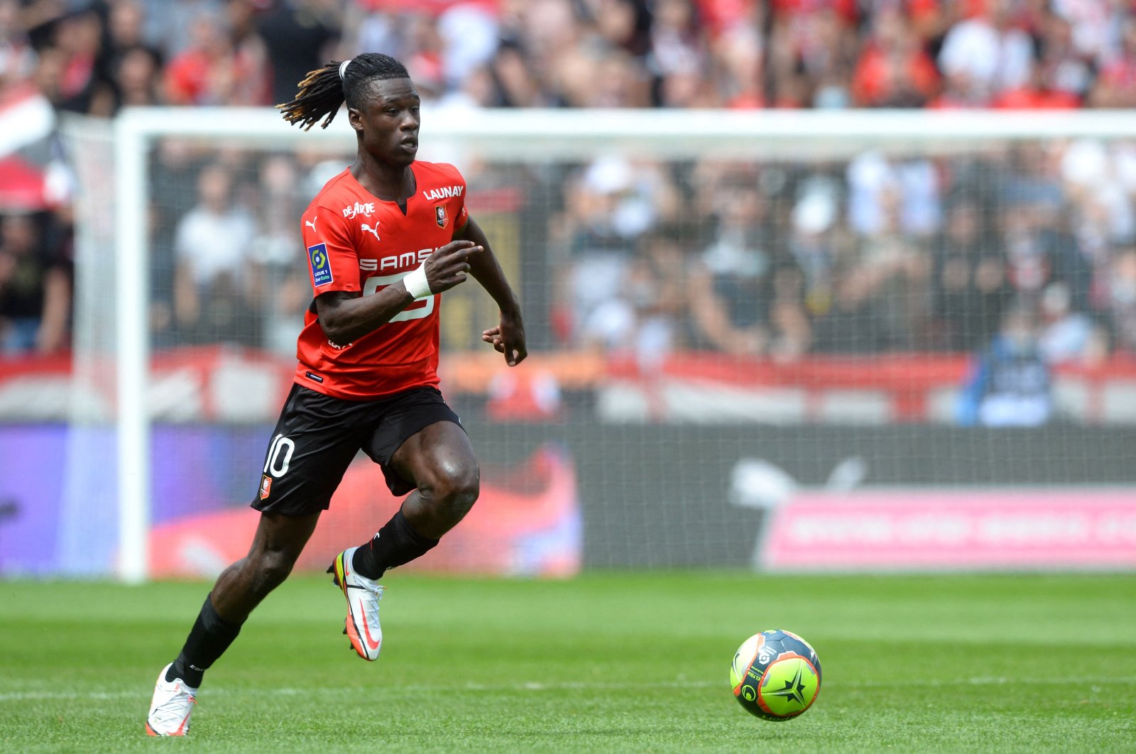 Rennes' French midfielder Eduardo Camavinga runs with the ball during the Ligue 1 football match between Rennes and Lens at The Roazhon Park Stadium in Rennes, northern France, Aug. 8, 2021. (AFP Photo)