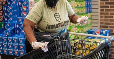 A woman sanitizes a grocery cart before shopping at a local grocery store as the spread of the COVID-19 continues, in District Heights, Maryland, U.S., Oct. 6, 2020. (Reuters Photo)