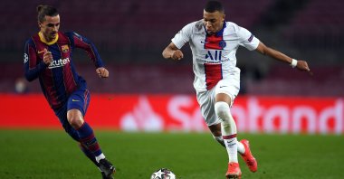 PSG's Kylian Mbappe tries to go past Barcelona's Antoine Griezmann during a Champions League Round of 16 match at Camp Nou, Barcelona, Spain, Feb. 16, 2021. (Getty Images)