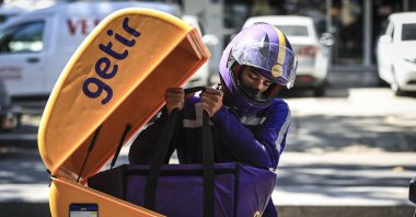 A Getir employee takes out groceries from his motorcycle, Aug. 8, 2021. (AA Photo)