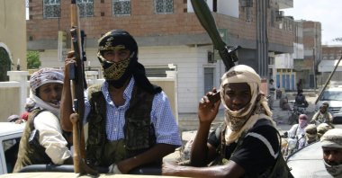Members of Ansar al-Sharia, an al-Qaida affiliated group, carry their weapons as they ride on a truck in the town of Jaar, southern Yemen, April 28, 2012. (Reuters Photo)