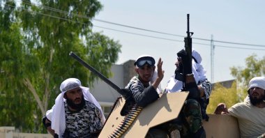 Taliban fighters atop a Humvee vehicle parade along a road to celebrate after the U.S. pulled all its troops out of Afghanistan, in Kandahar, Afghanistan, Sept. 1, 2021. (Photo by Javed Tanveer via AFP)