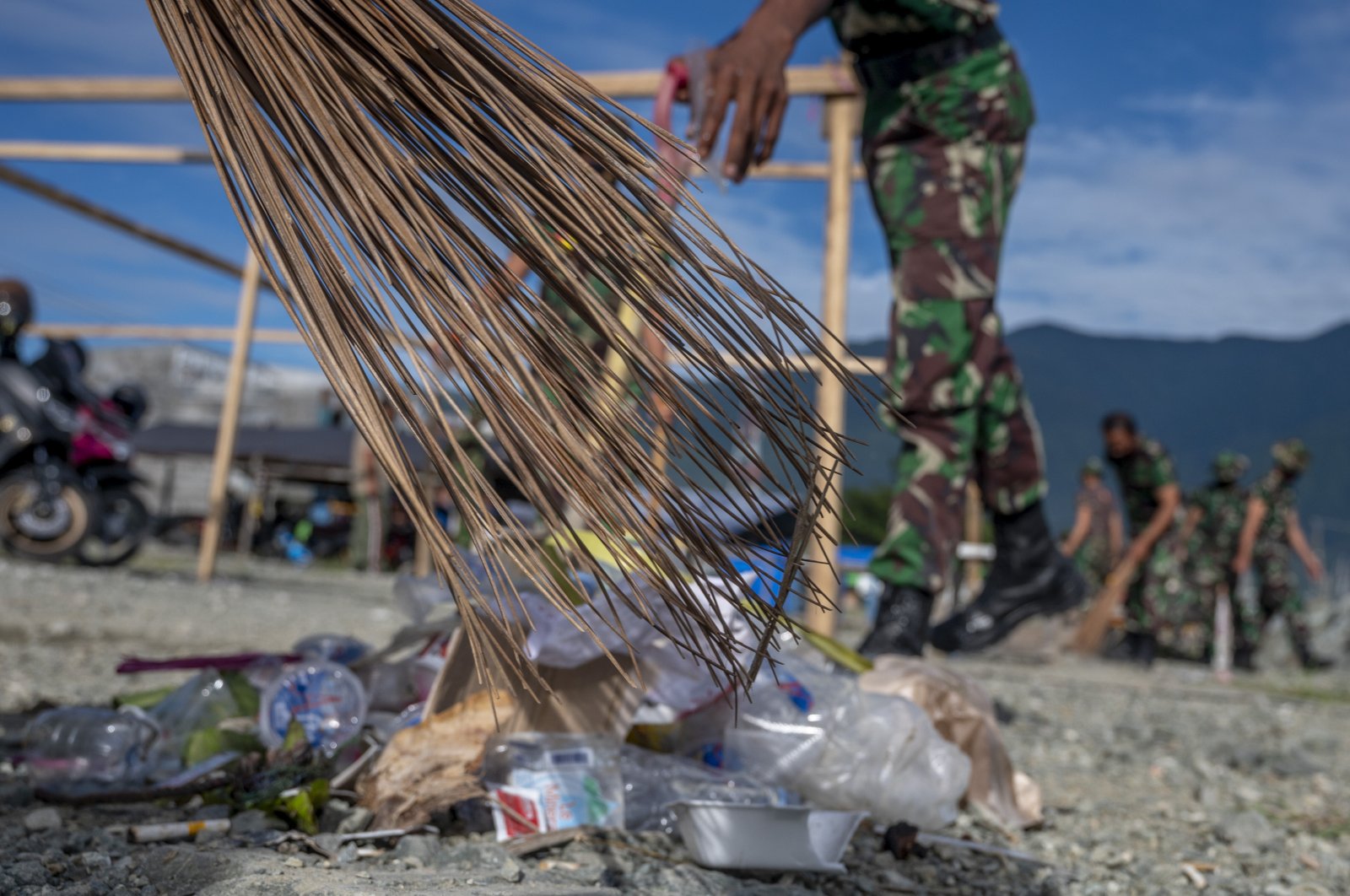 Indonesian soldiers pick up plastic waste scattered in the Talise Beach area, Palu, Central Sulawesi Province, Indonesia on July 23, 2021. (NurPhoto via Getty Images)