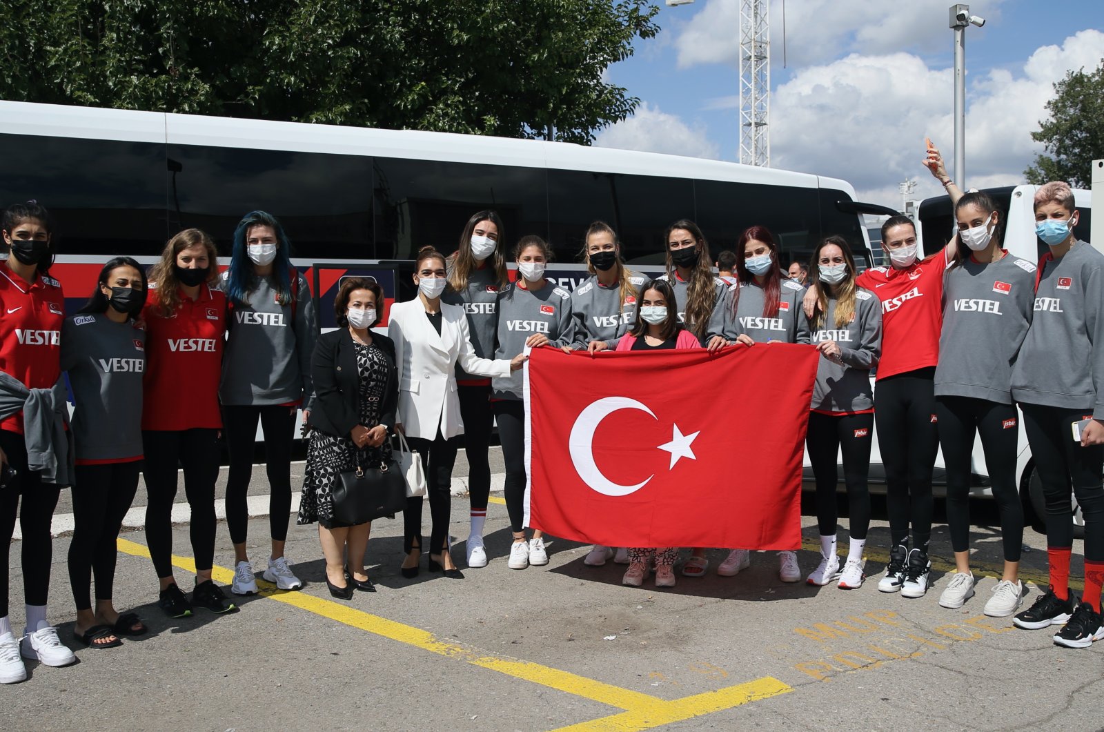 Turkey women's national volleyball team and local Turkish officials pose for a photo at the Nikola Tesla Airport, Belgrade, Serbia, Sept. 1, 2021. (AA Photo)