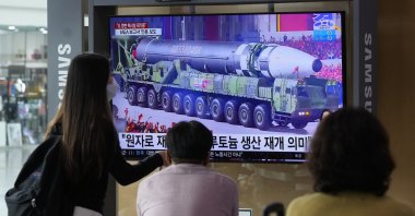 People watch a TV screen showing a file image of a North Korean missile in a military parade during a news program at the Seoul Railway Station in Seoul, South Korea, Aug. 30, 2021. (AP Photo)