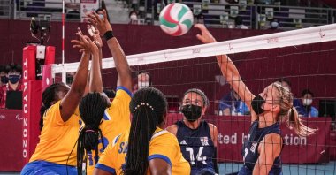 USA's Lora Webster (R) spikes the ball during the sitting volleyball pool match between USA and Rwanda during the Tokyo 2020 Paralympic Games at Makuhari Messe Hall in Chiba, Japan, Aug. 28, 2021. (Photo by Yasuyoshi CHIBA via AFP)