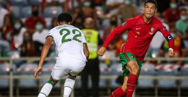 Portugal forward Cristiano Ronaldo (R) goes past Republic of Ireland defender Andrew Omobamidele during their World Cup European qualifying match in Faro, southern Portugal, Sept. 1, 2021. (AFP Photo)