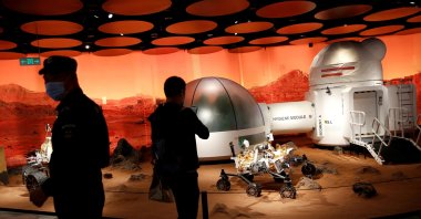 People inspect models of a Mars base and a rover displayed inside the SKP-S shopping mall in Beijing, China, Sept. 23, 2020. (Reuters File Photo)