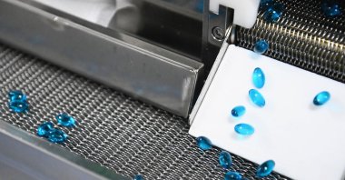 Capsules for treating cold move along a conveyor at a factory in Wuhan, Hubei province, China, Aug. 11, 2021. (Getty Images )