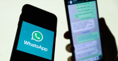 The WhatsApp logo is displayed on a phone screen and a conversation on WhatsApp is displayed on a phone screen in the background in this illustration photo taken in Krakow, Poland, Aug. 27, 2021. (Reuters File Photo)