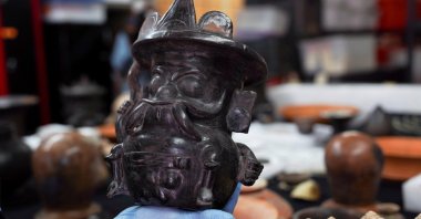 Archaeologist Sergio Gomez displays a pot shaped in the image of storm god Tlaloc, found inside a 2,000-year-old tunnel built under the ornate Feathered Serpent Pyramid, in the ruins of Teotihuacan, in San Juan Teotihuacan, Mexico, Aug. 12, 2021. (Reuters Photo)