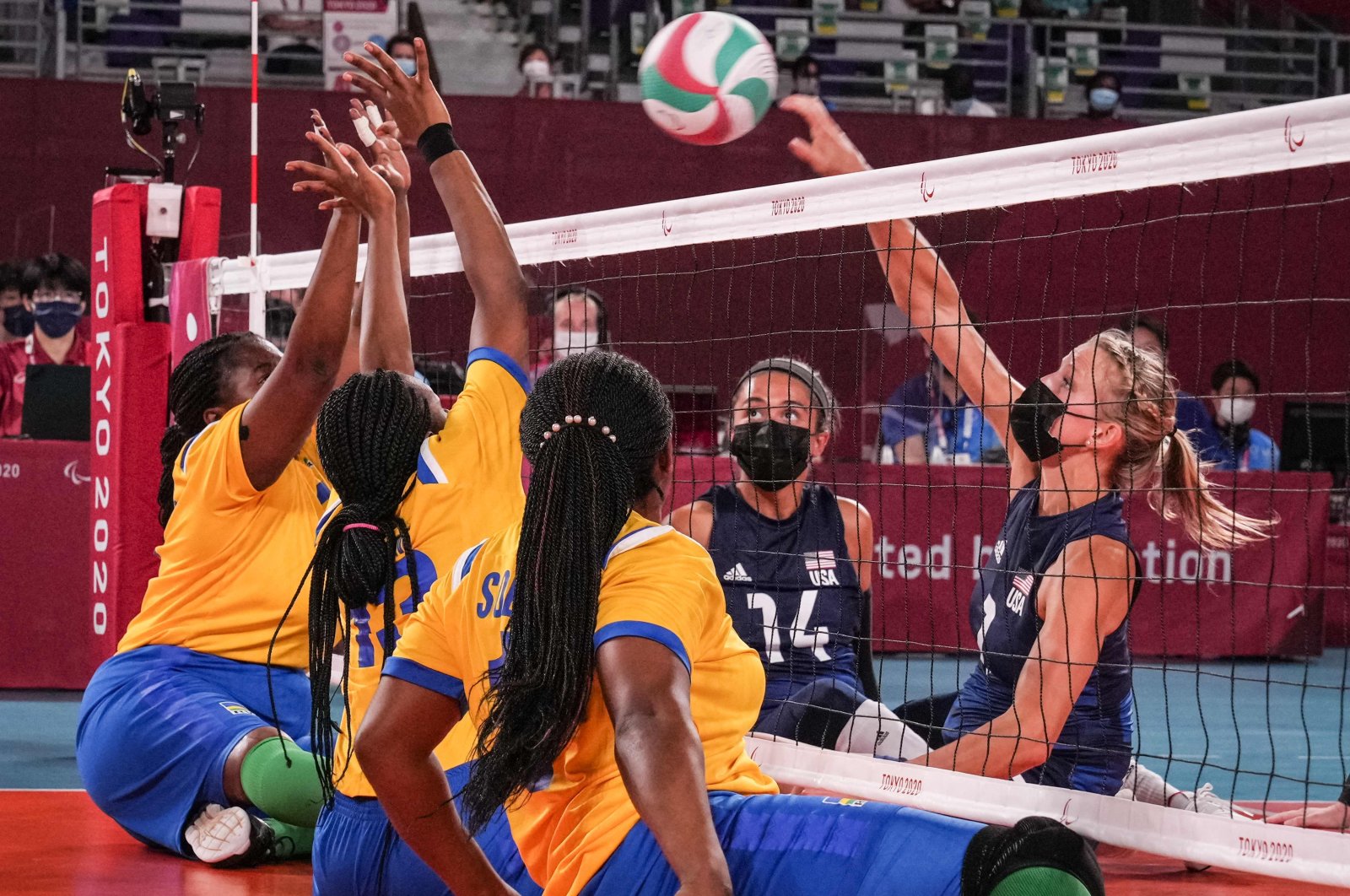 USA's Lora Webster (R) spikes the ball during the sitting volleyball pool match between USA and Rwanda during the Tokyo 2020 Paralympic Games at Makuhari Messe Hall in Chiba, Japan, Aug. 28, 2021. (Photo by Yasuyoshi CHIBA via AFP)