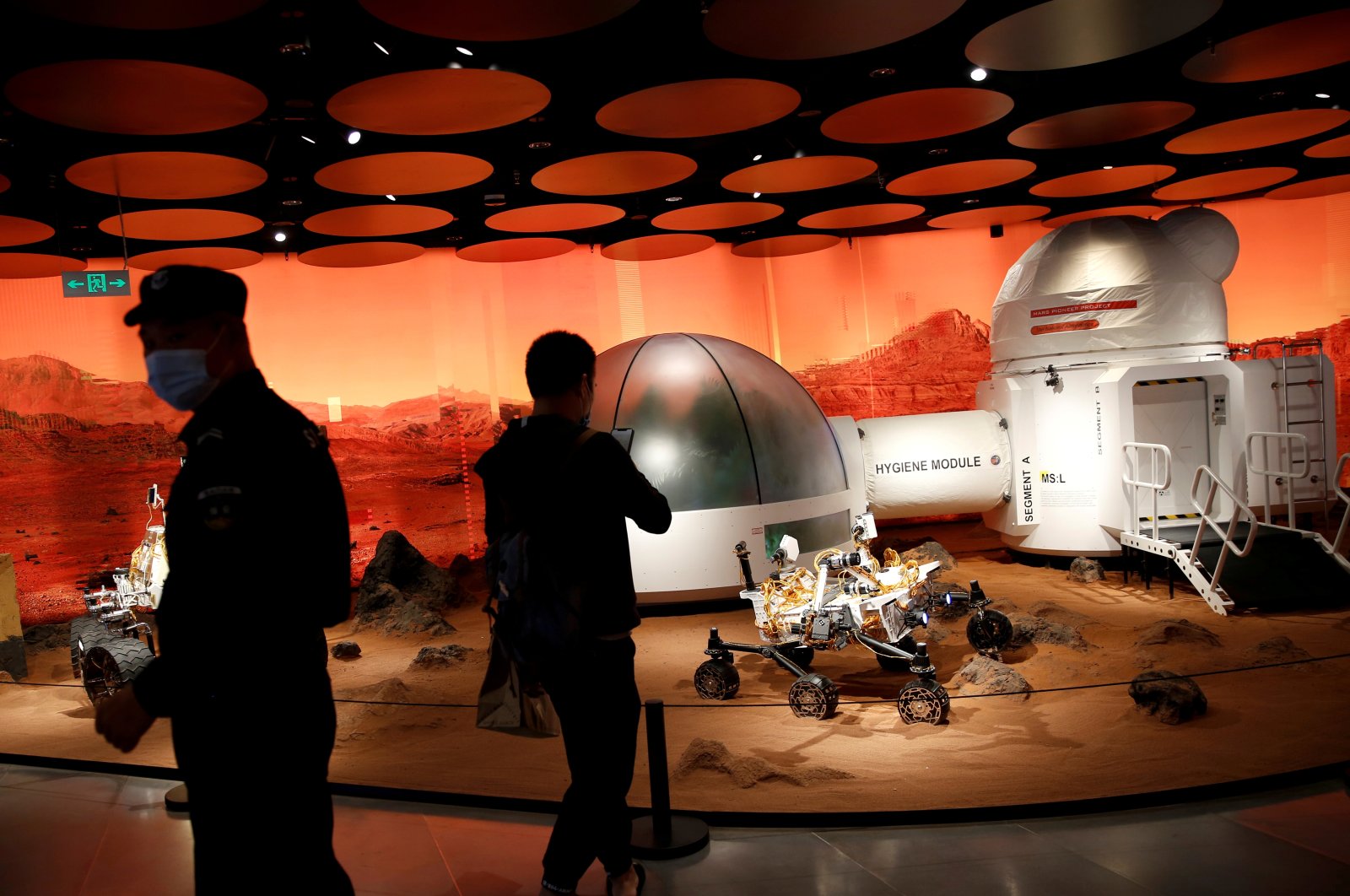 People inspect models of a Mars base and a rover displayed inside the SKP-S shopping mall in Beijing, China, Sept. 23, 2020. (Reuters File Photo)