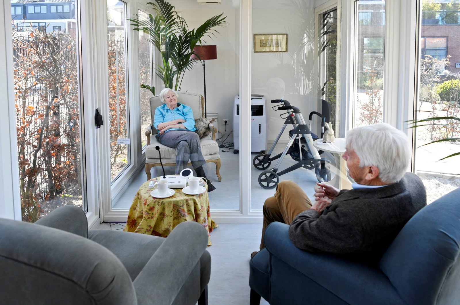 A man visits his wife at a care facility for elderly people with dementia in a glass house that has been built to combat loneliness after a visit ban was imposed due to the coronavirus outbreak in Wassenaar, Netherlands, April 9, 2020. (Reuters Photo)