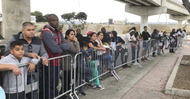Asylum seekers in Tijuana, Mexico, listen to names being called from a waiting list to claim asylum at a border crossing in San Diego, California, U.S., Sept. 26, 2019. (AP Photo)