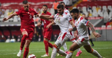 Turkey defender Merih Demiral (L) fights for the ball with Montenegro's Igor Vujacic (C) and Stefan Savic (R) during their FIFA World Cup Qatar 2022 qualifier at the Vodafone Stadium, Istanbul, Turkey, Sept. 1, 2021. (AFP Photo)
