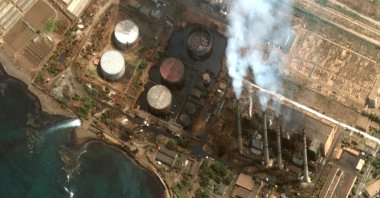 A handout satellite image made available by Maxar Technologies shows oil pooling around a set of oil storage tanks at the Baniyas power plant and spilling into the Mediterranean, in Baniyas, Syria, Aug. 28, 2021. (Photo by Maxar Technologies via EPA)
