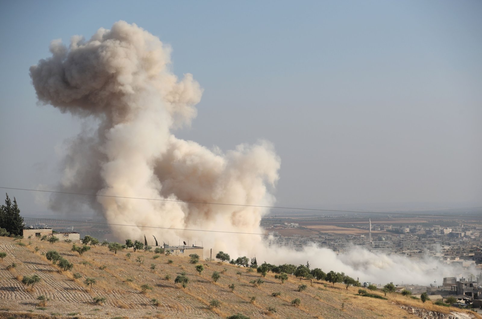 Smoke billowing above buildings during a reported airstrike by pro-regime forces on Khan Sheikhun in the south of the northwestern Syrian province of Idlib, Syria, Aug. 5, 2019. (AFP Photo)