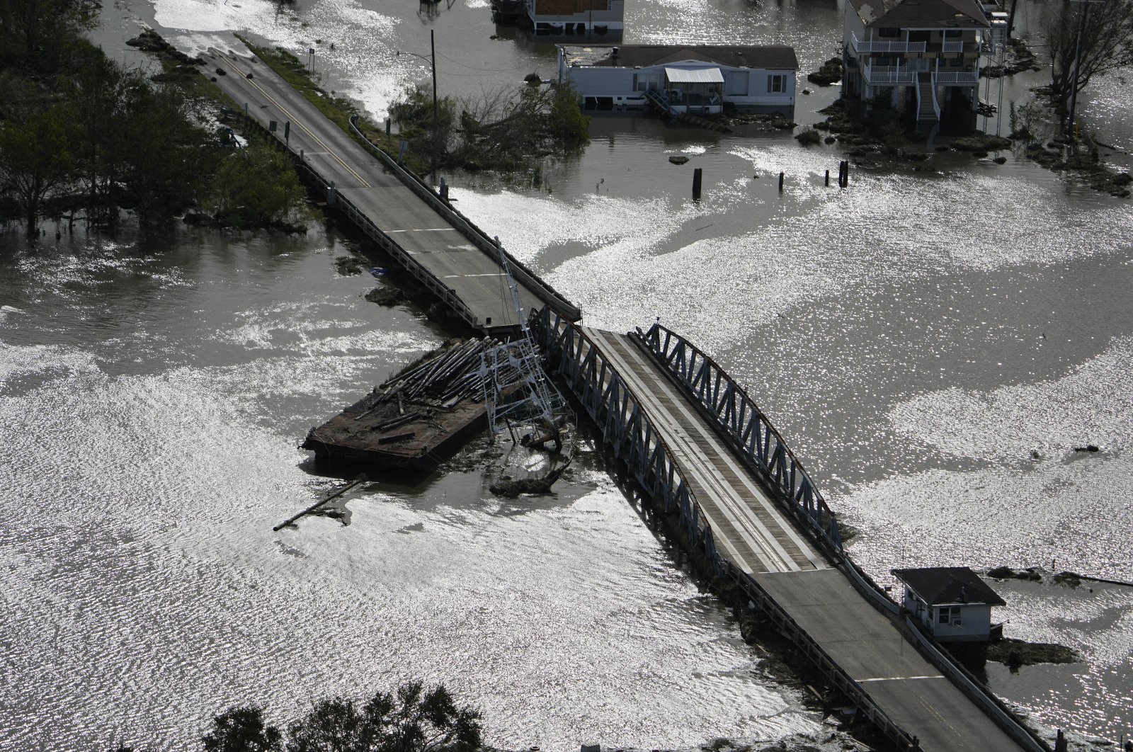 A barge damages a bridge that divides Lafitte, La., and Jean Lafitte, in the aftermath of Hurricane Ida, Aug. 30, 2021, in Lafitte, La. (AP Photo)