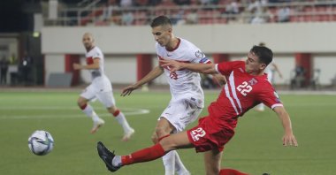 Turkey's Mert Müldür in action with Gibraltar's Graeme Torrilla at the World Cup Fifa Qualifiers Group G match in Victoria Stadium, Gibraltar, Sept. 4, 2021. (Reuters Photo)