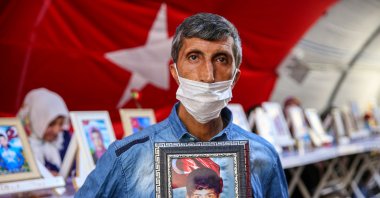 Şevket Bingöl holds a picture of his son who was abducted by the PKK, Diyarbakır, southeastern Turkey, Sept. 4, 2021. (AA Photo)