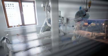 Intensive care nurse Sandy Plückhahn (L) and Mirjana Suljagic, X-ray assistant, prepare a patient suffering from COVID-19 for a lung X-ray in the intensive care unit of Bethel Hospital Berlin. The Bundestag will continue to debate the expanded Infection Protection Act on April 21, 2021, for uniform nationwide rules to contain the Corona pandemic to prevent overburdening the health care system.