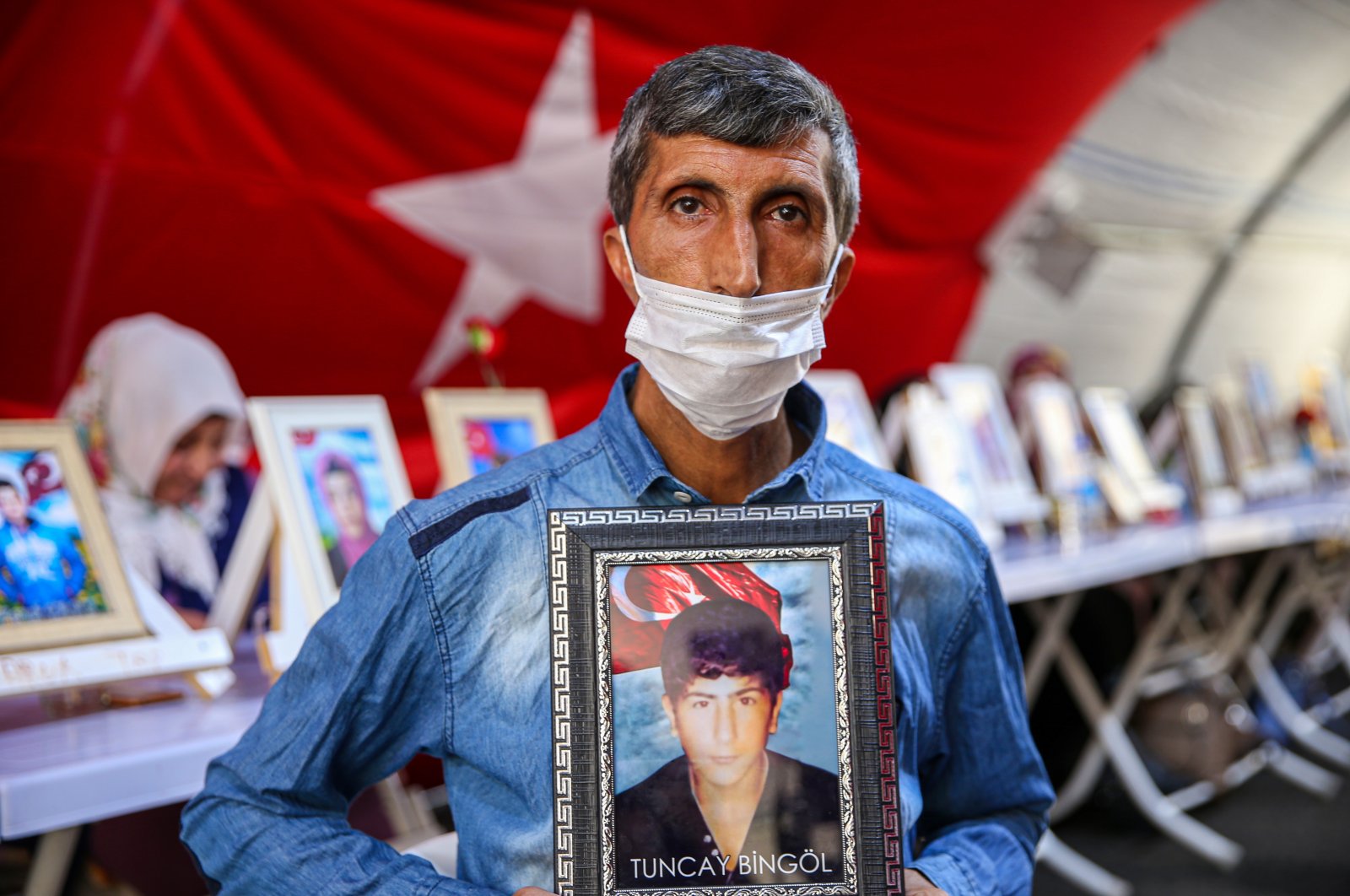 Şevket Bingöl holds a picture of his son who was abducted by the PKK, Diyarbakır, southeastern Turkey, Sept. 4, 2021. (AA Photo)