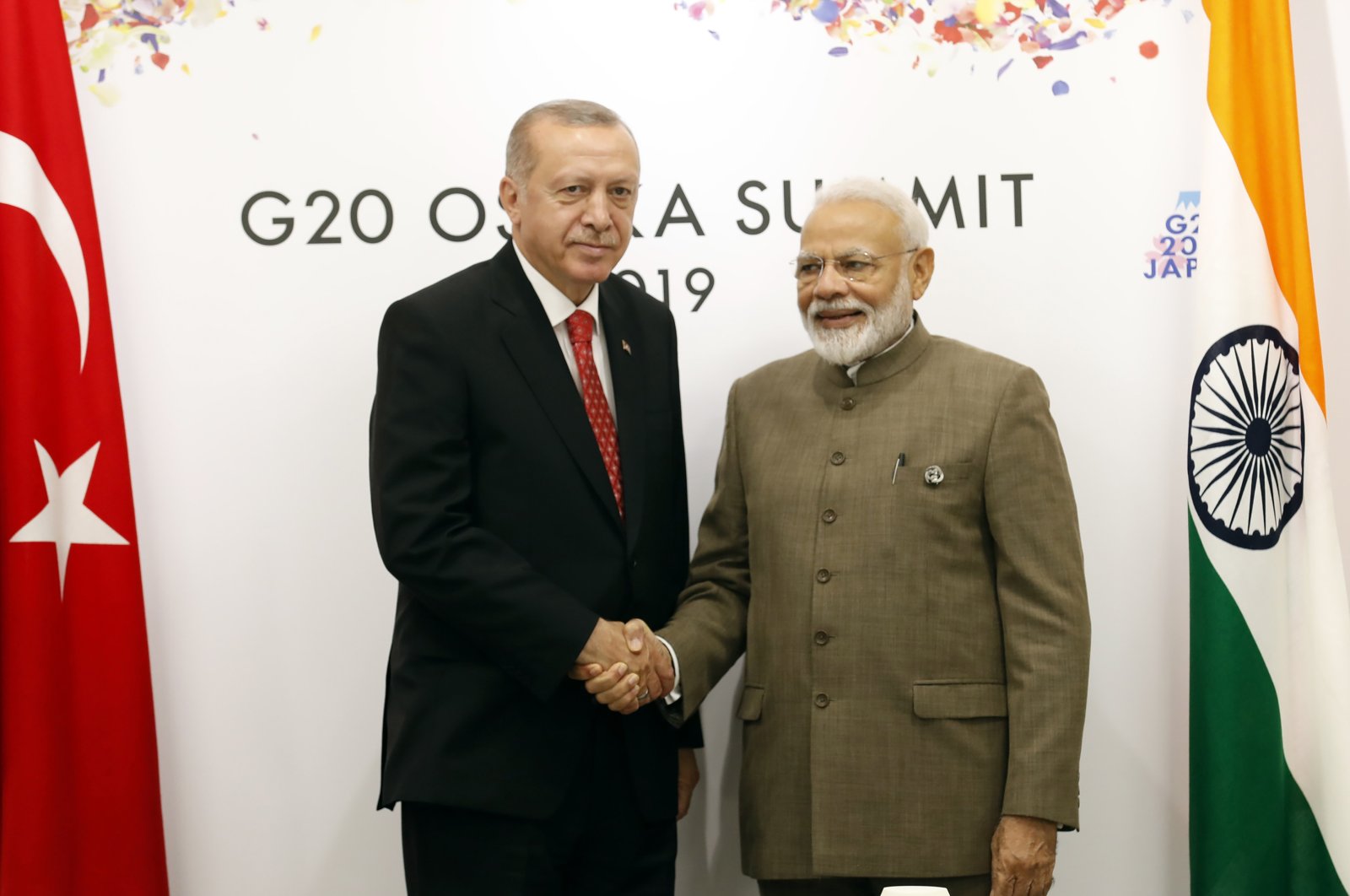 Turkey's President Recep Tayyip Erdoğan, left, shakes hands with India's Prime Minister Narendra Modi, right, prior to their meeting on the sidelines of the G-20 summit in Osaka, Japan, Saturday, June 29, 2019. (Presidential Press Service via AP, Pool)