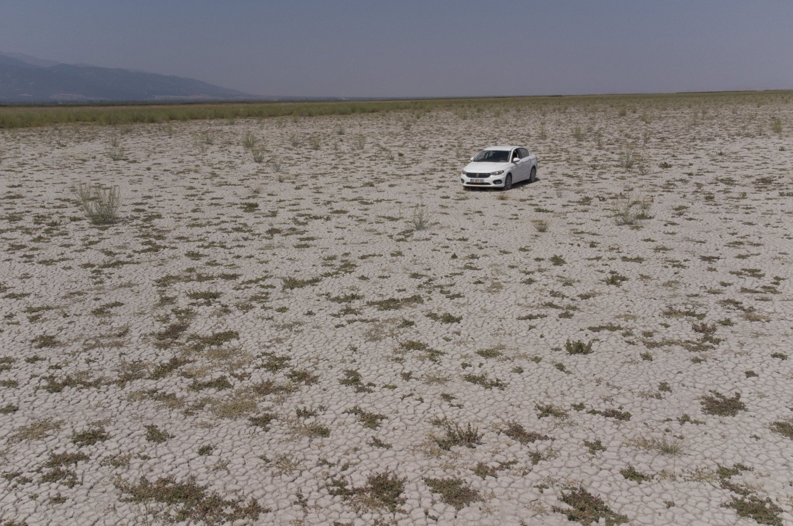 A car drives on the bed of completely dried Lake Akşehir in Konya, Turkey, Aug. 27, 2021. (DHA Photo)