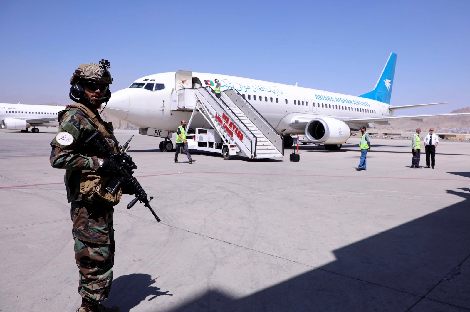 A member of Taliban forces stands guard next to a plane that has arrived from Kandahar at Kabul Hamid Karzai International Airport in Kabul, Afghanistan, Sept. 5, 2021. (Reuters Photo)
