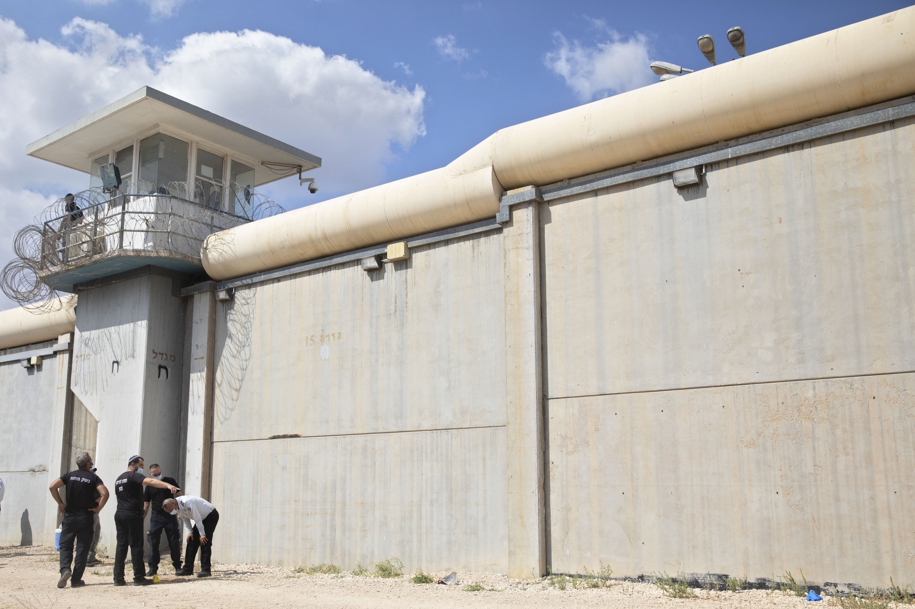 Police officers and prison guards inspect the scene of a prison escape outside the Gilboa prison in northern Israel, Monday, Sept. 6, 2021. (AP Photo)
