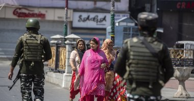 Indian paramilitary soldiers patrol as civilians walk in a deserted market area in Srinagar, Indian-controlled Kashmir, Sept. 2, 2021. (AP Photo)
